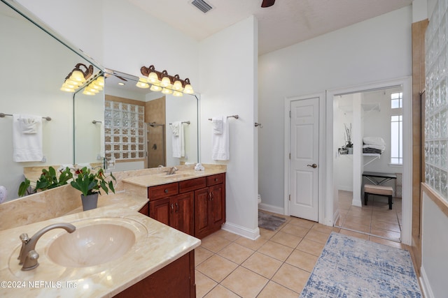 bathroom featuring vanity, tile patterned floors, and walk in shower