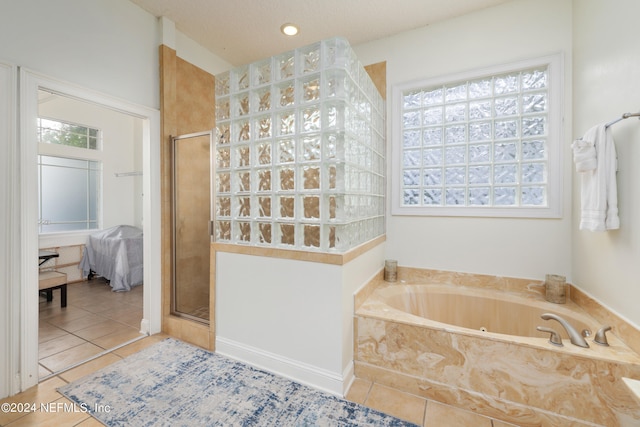 bathroom with independent shower and bath, plenty of natural light, and tile patterned flooring