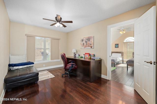 office area with dark wood-type flooring, a textured ceiling, and ceiling fan