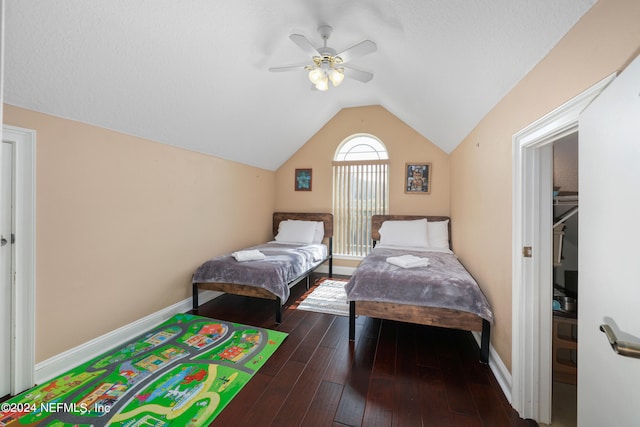 bedroom featuring dark wood-type flooring, ceiling fan, and lofted ceiling