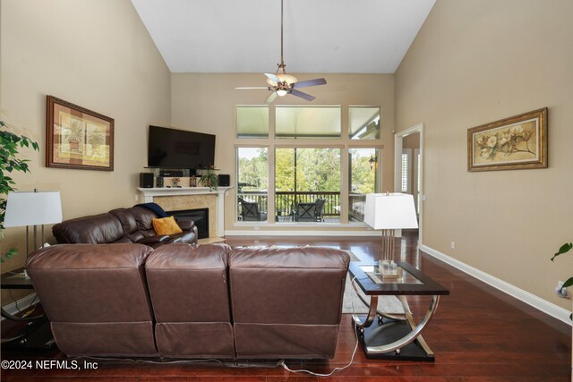 living room with dark hardwood / wood-style floors, high vaulted ceiling, and ceiling fan