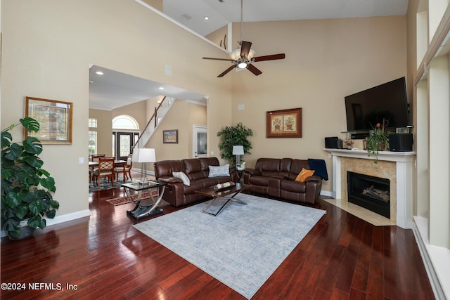 living room with a premium fireplace, ceiling fan, high vaulted ceiling, and dark hardwood / wood-style flooring