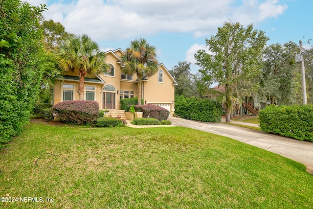 view of front of property with a front lawn and a garage