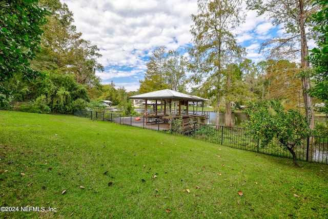 view of yard featuring a water view, a gazebo, and a patio