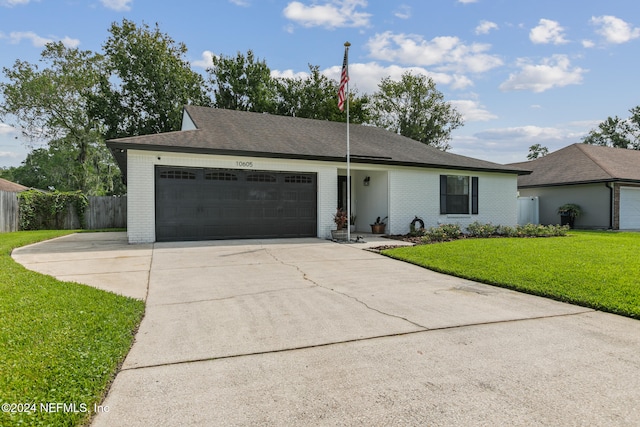 ranch-style house featuring a front yard and a garage