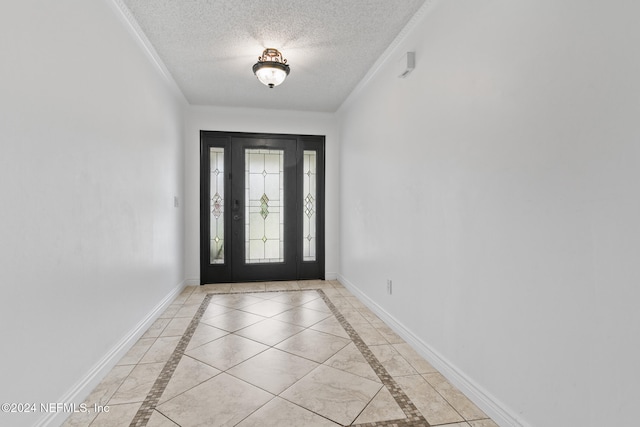 tiled foyer entrance with crown molding and a textured ceiling