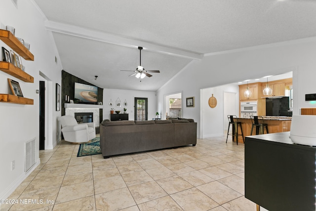 living room with beam ceiling, high vaulted ceiling, light tile patterned floors, and ceiling fan