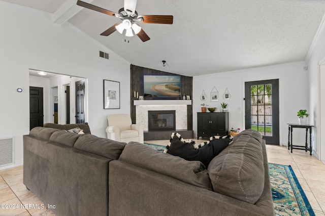 tiled living room with vaulted ceiling with beams, a textured ceiling, and ceiling fan