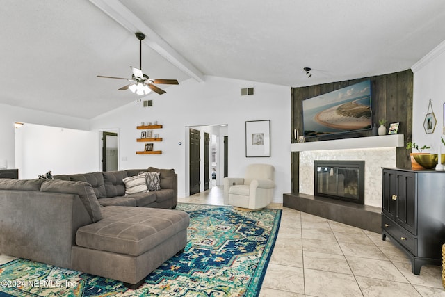 living room with a textured ceiling, lofted ceiling with beams, and ceiling fan