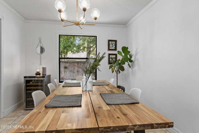 dining room with wine cooler, ornamental molding, a textured ceiling, and an inviting chandelier