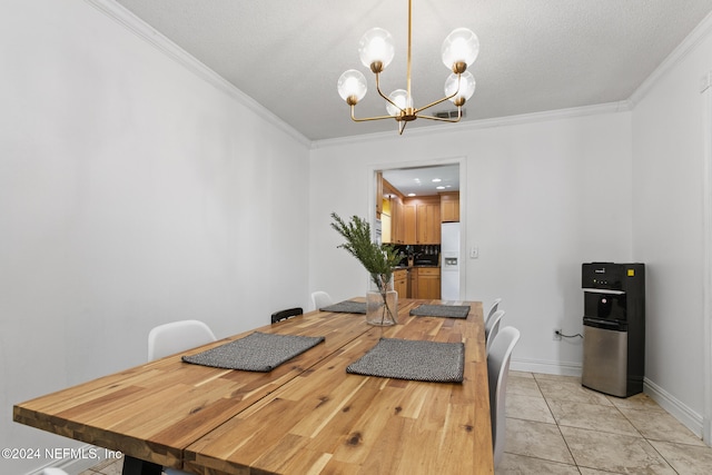 tiled dining room featuring an inviting chandelier, ornamental molding, and a textured ceiling