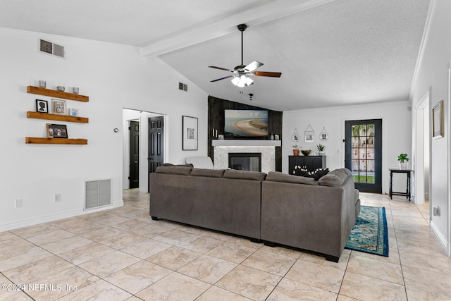 living room with lofted ceiling with beams, a textured ceiling, and ceiling fan