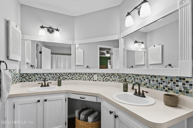 bathroom featuring vanity, a textured ceiling, tasteful backsplash, and ceiling fan