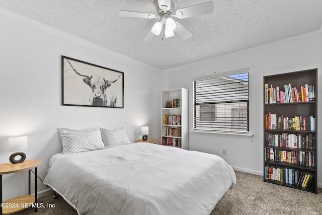 bedroom with ornamental molding, a textured ceiling, carpet flooring, and ceiling fan