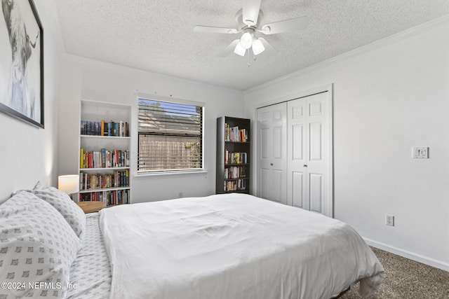 carpeted bedroom with ornamental molding, a closet, a textured ceiling, and ceiling fan