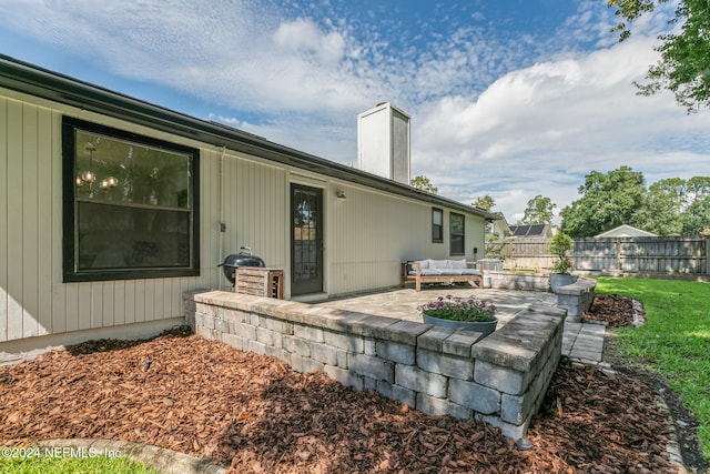 rear view of house featuring a yard and a patio