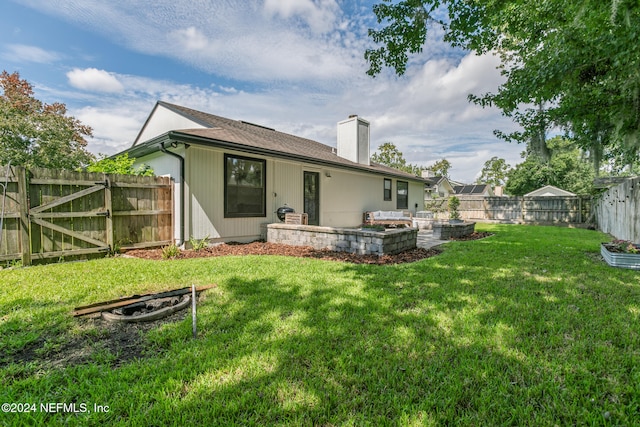 rear view of property featuring a yard and a patio