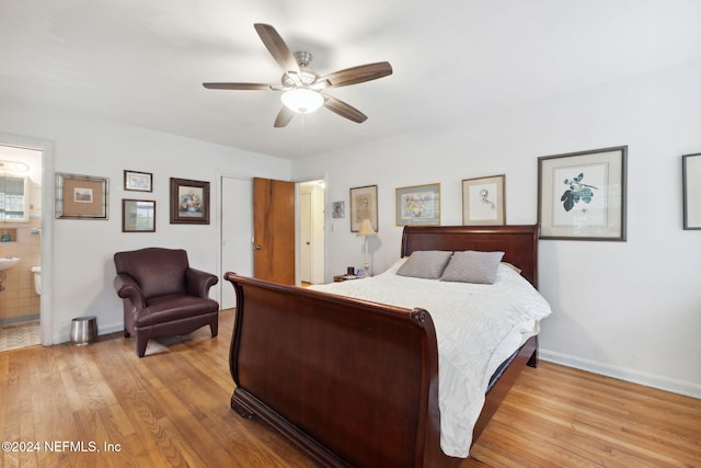 bedroom with connected bathroom, ceiling fan, and light hardwood / wood-style flooring