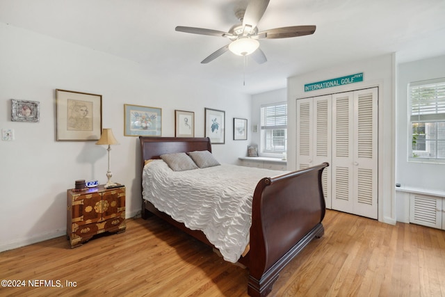 bedroom featuring light hardwood / wood-style floors, a closet, and ceiling fan