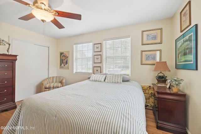 bedroom with light hardwood / wood-style flooring and ceiling fan