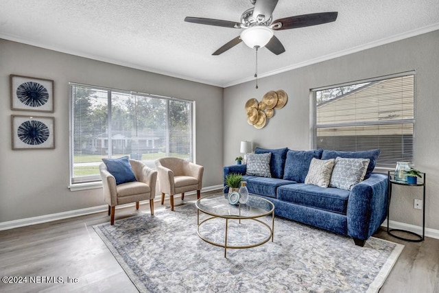 living room with a textured ceiling, crown molding, hardwood / wood-style flooring, and ceiling fan