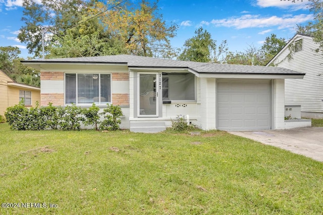 ranch-style house with a garage and a front lawn