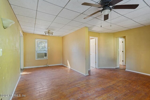 spare room featuring hardwood / wood-style floors, a paneled ceiling, and ceiling fan