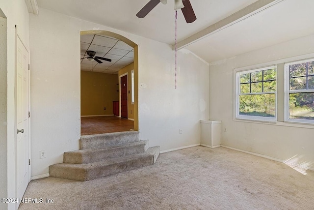 117 Tyre Rd, Palatka, FL 32177 - carpeted empty room featuring a ceiling fan, stairway, baseboards, beamed ceiling, and arched walkways