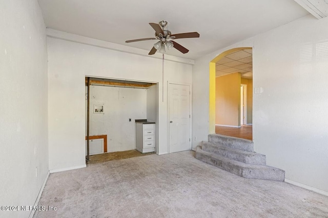 empty room with light colored carpet and ceiling fan