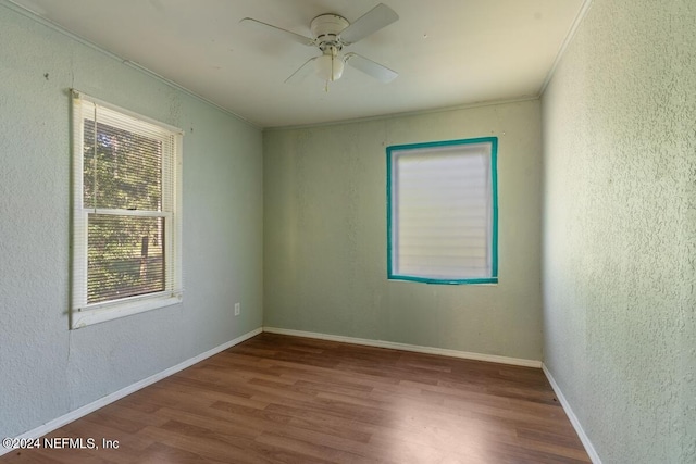 unfurnished room featuring crown molding, wood-type flooring, and ceiling fan