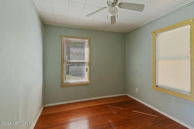 spare room with ceiling fan, ornamental molding, and dark hardwood / wood-style floors