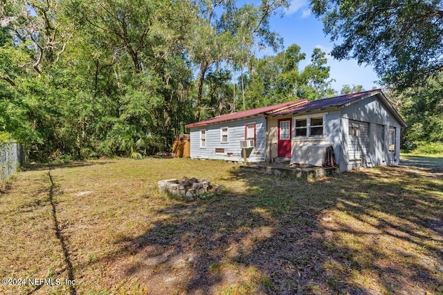 117 Tyre Rd, Palatka, FL 32177 - back of house featuring an outdoor fire pit, metal roof, and cooling unit