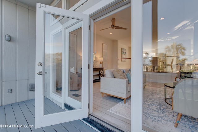 view of exterior entry featuring a balcony and ceiling fan