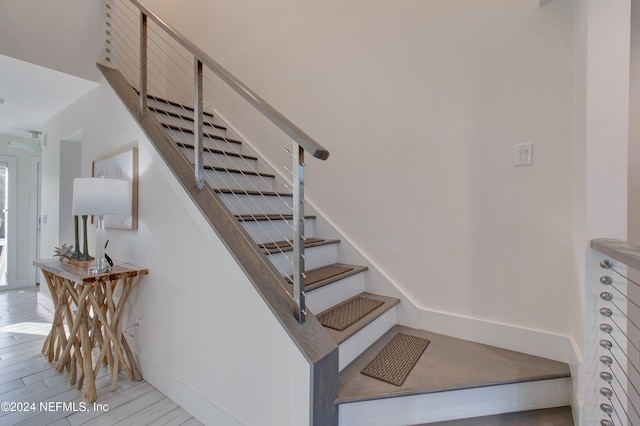 staircase featuring hardwood / wood-style flooring