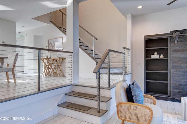 stairway featuring wood-type flooring