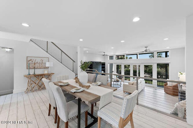 dining space with ceiling fan, light hardwood / wood-style floors, and french doors