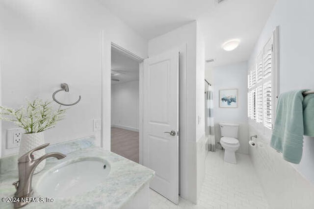 bathroom with tile patterned floors, vanity, toilet, and a shower with shower curtain