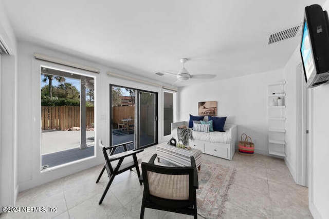 living room featuring ceiling fan and light tile patterned floors