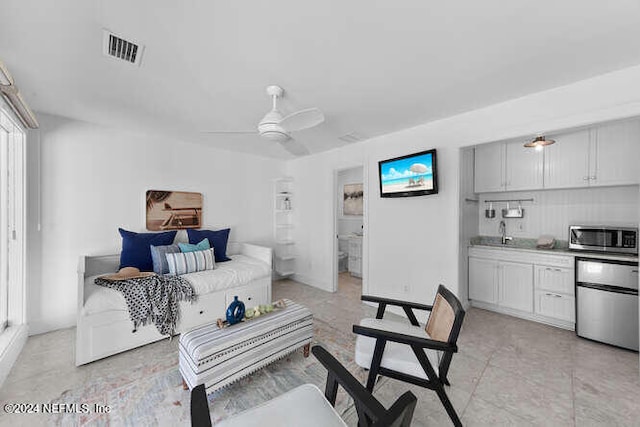 living room with ceiling fan and sink