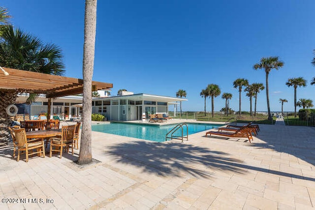 view of swimming pool featuring a pergola and a patio