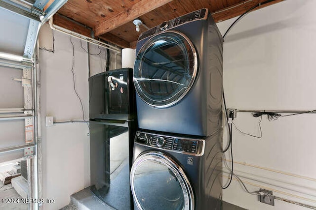 clothes washing area featuring wooden ceiling and stacked washer and clothes dryer