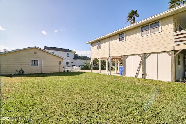 back of house featuring a yard