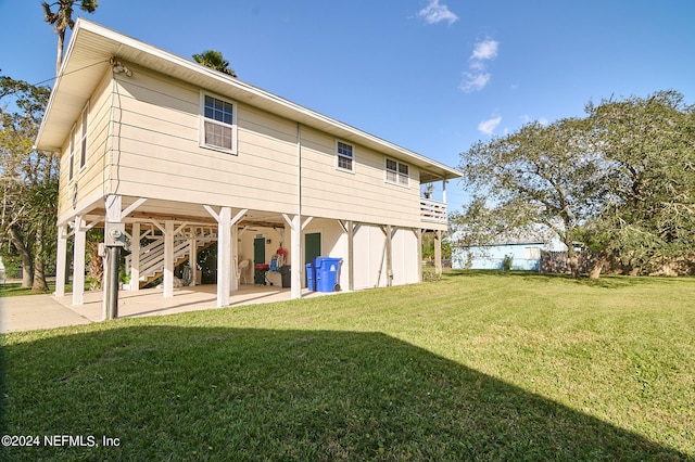 rear view of house with a patio and a yard