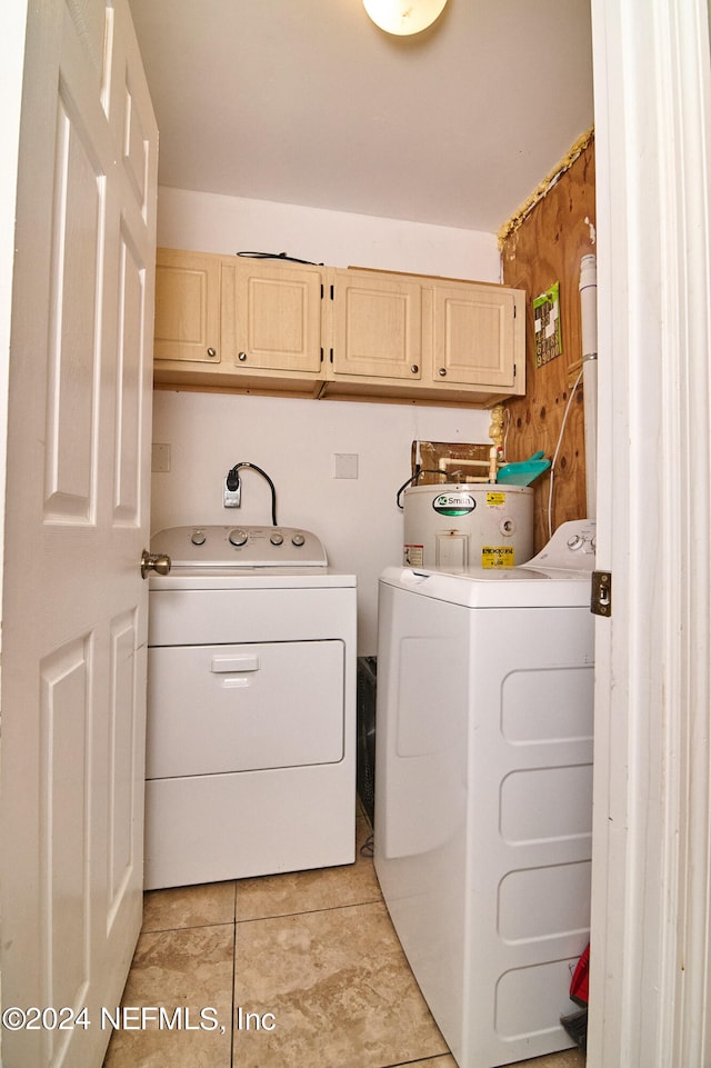 laundry room featuring washer and clothes dryer, cabinets, electric water heater, and light tile patterned floors