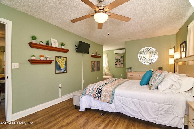 bedroom featuring a textured ceiling, hardwood / wood-style floors, ceiling fan, and a wall mounted air conditioner