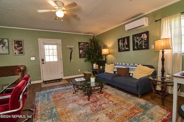 living room featuring ceiling fan, dark hardwood / wood-style floors, ornamental molding, and a wall mounted air conditioner