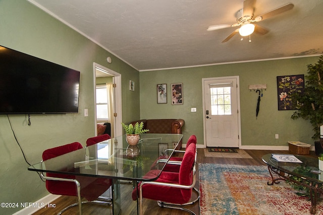 dining space featuring ornamental molding, dark hardwood / wood-style flooring, and ceiling fan