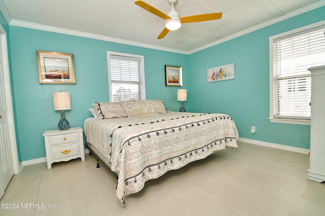 tiled bedroom with a textured ceiling, ceiling fan, and crown molding