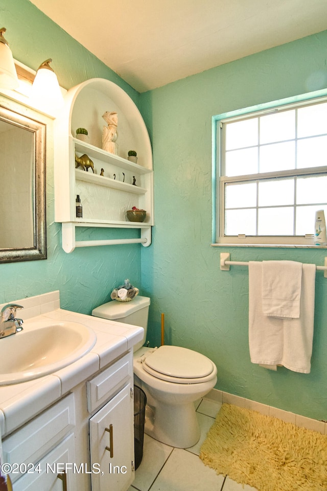 bathroom with vanity, tile patterned flooring, and toilet