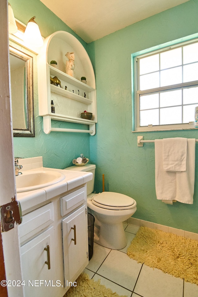 bathroom featuring tile patterned flooring, vanity, and toilet